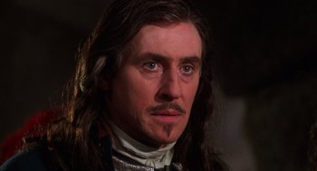 Movie still from “The Man in the Iron Mask” (1998), directed by Randall Wallace – A person with long brown hair; Close Up shot, Low angle