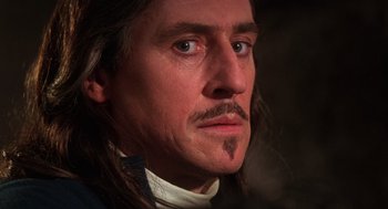 Movie still from “The Man in the Iron Mask” (1998), directed by Randall Wallace – A person with long black hair; Close Up shot, Low angle