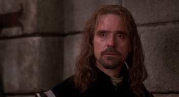 Movie still from “The Man in the Iron Mask” (1998), directed by Randall Wallace – A person with long hair and a beard; Close Up shot, Over the shoulder angle