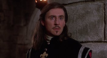 Movie still from “The Man in the Iron Mask” (1998), directed by Randall Wallace – A person with long brown hair; Close Up shot, Low angle