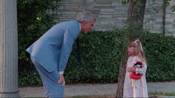 Movie still from “The Man with Two Brains” (1983), directed by Carl Reiner – An older man and a young girl standing next to a tree; Medium shot, Over the shoulder angle