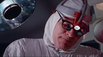 Movie still from “The Man with Two Brains” (1983), directed by Carl Reiner – A man wearing a white helmet and glasses; Close Up shot, Low angle