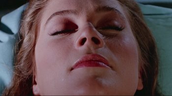 Movie still from “The Man with Two Brains” (1983), directed by Carl Reiner – A woman's face with her eyes closed; Extreme Close Up shot, Overhead angle
