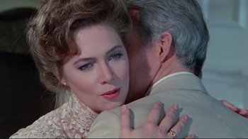 Movie still from “The Man with Two Brains” (1983), directed by Carl Reiner – An older man hugging a beautiful young woman; Close Up shot, Over the shoulder angle