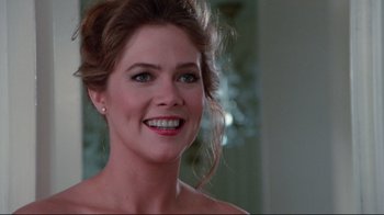 Movie still from “The Man with Two Brains” (1983), directed by Carl Reiner – A person with a smile on their face; Close Up shot, Over the shoulder angle