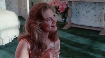 Movie still from “The Man with Two Brains” (1983), directed by Carl Reiner – A beautiful woman holding a glass of wine; Close Up shot, Over the shoulder angle