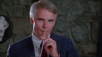 Movie still from “The Man with Two Brains” (1983), directed by Carl Reiner – A person wearing a suit and tie; Close Up shot, High angle