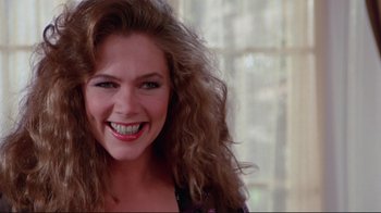 Movie still from “The Man with Two Brains” (1983), directed by Carl Reiner – A person with curly hair smiling; Close Up shot, Over the shoulder angle