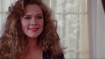 Movie still from “The Man with Two Brains” (1983), directed by Carl Reiner – A person with long curly hair; Close Up shot, Over the shoulder angle