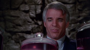 Movie still from “The Man with Two Brains” (1983), directed by Carl Reiner – A person wearing a suit and tie; Close Up shot, Over the shoulder angle