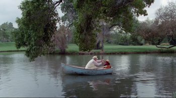 Movie still from “The Man with Two Brains” (1983), directed by Carl Reiner – Two people in a boat on a river; Wide shot, High angle