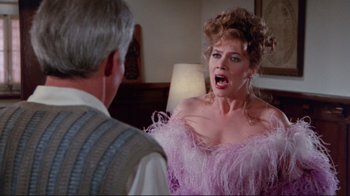Movie still from “The Man with Two Brains” (1983), directed by Carl Reiner – A woman in a pink dress is yelling at a man in a suit; Medium shot, Over the shoulder angle