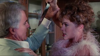 Movie still from “The Man with Two Brains” (1983), directed by Carl Reiner – A man and a woman are fighting with a knife; Close Up shot, Over the shoulder angle