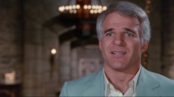 Movie still from “The Man with Two Brains” (1983), directed by Carl Reiner – A man in a blue suit and white shirt; Close Up shot, Over the shoulder angle