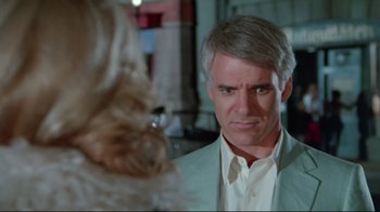 Movie still from “The Man with Two Brains” (1983), directed by Carl Reiner – A man in a white suit stares at a woman in a white suit; Close Up shot, Over the shoulder angle