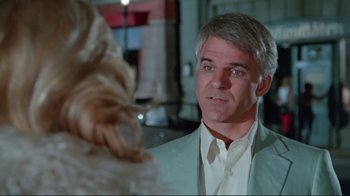 Movie still from “The Man with Two Brains” (1983), directed by Carl Reiner – A man in a white shirt is looking at a cat; Close Up shot, Over the shoulder angle