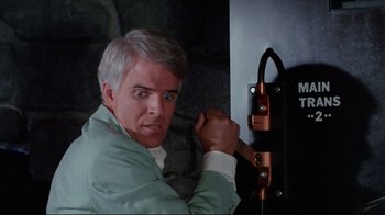 Movie still from “The Man with Two Brains” (1983), directed by Carl Reiner – A man holding a knife in front of a door; Close Up shot, Overhead angle