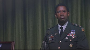 Movie still from “The Manchurian Candidate” (2004), directed by Jonathan Demme – A man in a military uniform standing in front of a microphone; Close Up shot, Low angle