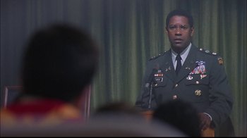 Movie still from “The Manchurian Candidate” (2004), directed by Jonathan Demme – A man in a military uniform standing in front of a microphone; Close Up shot, Over the shoulder angle
