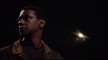 Movie still from “The Manchurian Candidate” (2004), directed by Jonathan Demme – A person wearing sunglasses and a jacket; Close Up shot, Over the shoulder angle