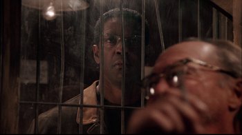 Movie still from “The Manchurian Candidate” (2004), directed by Jonathan Demme – A man in a jail cell looking through the bars; Close Up shot, Over the shoulder angle