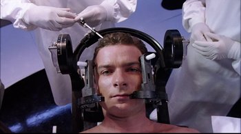 Movie still from “The Manchurian Candidate” (2004), directed by Jonathan Demme – A man is getting his head examined by a doctor; Close Up shot, High angle