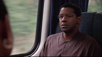 Movie still from “The Manchurian Candidate” (2004), directed by Jonathan Demme – A man sitting on a train looking out the window; Close Up shot, Over the shoulder angle