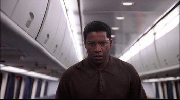 Movie still from “The Manchurian Candidate” (2004), directed by Jonathan Demme – A man in a brown shirt is standing in a hallway; Close Up shot, Low angle