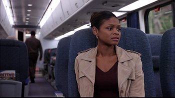 Movie still from “The Manchurian Candidate” (2004), directed by Jonathan Demme – A woman sitting on a seat on an airplane; Medium shot, Over the shoulder angle