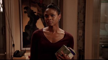 Movie still from “The Manchurian Candidate” (2004), directed by Jonathan Demme – A woman holding a box in her hands; Medium shot, Over the shoulder angle