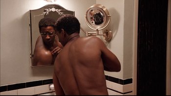 Movie still from “The Manchurian Candidate” (2004), directed by Jonathan Demme – A man in a bathroom looking in the mirror; Medium shot, Low angle