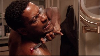 Movie still from “The Manchurian Candidate” (2004), directed by Jonathan Demme – A man shaving his face with a razor blade; Close Up shot, High angle