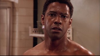 Movie still from “The Manchurian Candidate” (2004), directed by Jonathan Demme – A person wearing glasses; Close Up shot, Over the shoulder angle