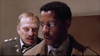 Movie still from “The Manchurian Candidate” (2004), directed by Jonathan Demme – A man in glasses and a man with a mustache; Close Up shot, Low angle