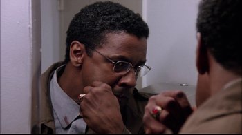 Movie still from “The Manchurian Candidate” (2004), directed by Jonathan Demme – A person wearing glasses looking at a cell phone; Close Up shot, Over the shoulder angle