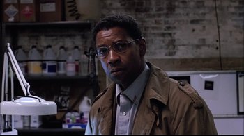 Movie still from “The Manchurian Candidate” (2004), directed by Jonathan Demme – A person wearing glasses and a jacket; Close Up shot, Low angle