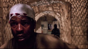 Movie still from “The Manchurian Candidate” (2004), directed by Jonathan Demme – A person wearing a hat; Close Up shot, Low angle