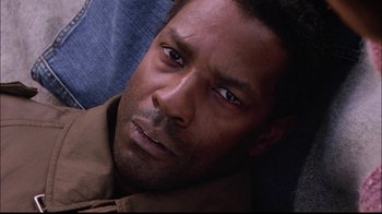 Movie still from “The Manchurian Candidate” (2004), directed by Jonathan Demme – A man's face as he stares into the camera; Close Up shot, High angle