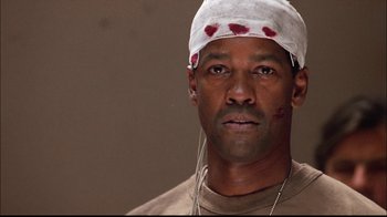 Movie still from “The Manchurian Candidate” (2004), directed by Jonathan Demme – A person wearing a bandage on his head; Close Up shot, High angle