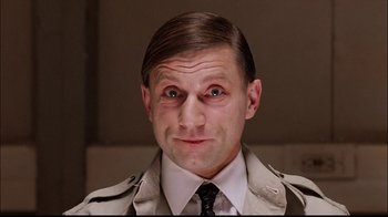 Movie still from “The Manchurian Candidate” (2004), directed by Jonathan Demme – A person wearing a suit and tie; Close Up shot, Low angle