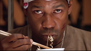 Movie still from “The Manchurian Candidate” (2004), directed by Jonathan Demme – A person eating food with chopsticks; Close Up shot, Low angle