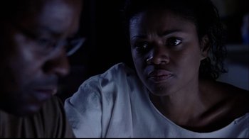 Movie still from “The Manchurian Candidate” (2004), directed by Jonathan Demme – A woman sitting next to a man in a dark room; Close Up shot, Over the shoulder angle