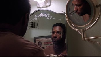 Movie still from “The Manchurian Candidate” (2004), directed by Jonathan Demme – A man looking in the mirror in front of a mirror; Close Up shot, Low angle