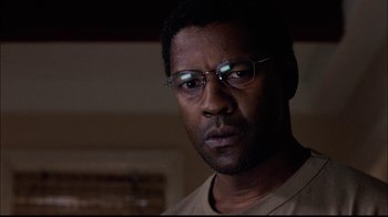 Movie still from “The Manchurian Candidate” (2004), directed by Jonathan Demme – A person wearing glasses; Close Up shot, Low angle