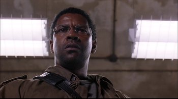 Movie still from “The Manchurian Candidate” (2004), directed by Jonathan Demme – A person wearing glasses in a room; Close Up shot, Low angle