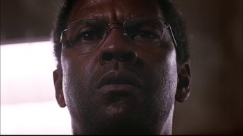 Movie still from “The Manchurian Candidate” (2004), directed by Jonathan Demme – A person wearing glasses; Close Up shot, Low angle