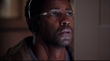 Movie still from “The Manchurian Candidate” (2004), directed by Jonathan Demme – A person wearing glasses and listening to music; Close Up shot, Low angle