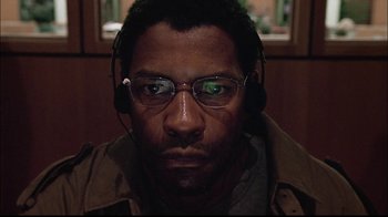 Movie still from “The Manchurian Candidate” (2004), directed by Jonathan Demme – A person wearing headphones and glasses; Close Up shot, Low angle