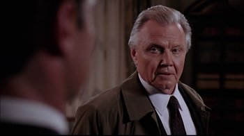 Movie still from “The Manchurian Candidate” (2004), directed by Jonathan Demme – An older man wearing a brown jacket and a tie; Close Up shot, Over the shoulder angle