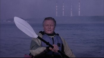 Movie still from “The Manchurian Candidate” (2004), directed by Jonathan Demme – An older man holding a paddle in a canoe; Medium shot, Low angle